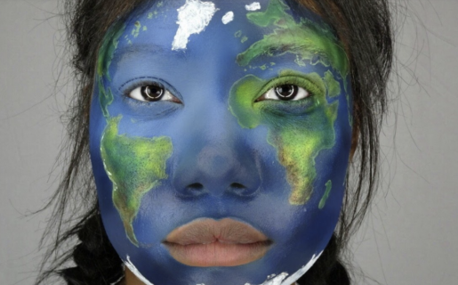 Girl's face with the earth on top of her eyes nose, and mouth