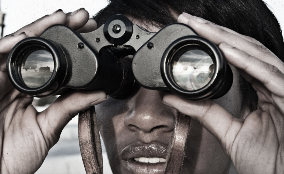 Person looking through binoculars