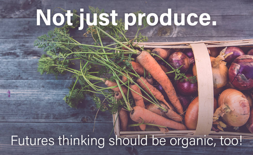 basket of leafy carrots and other vegetables stating foresight is not just produce but also organic