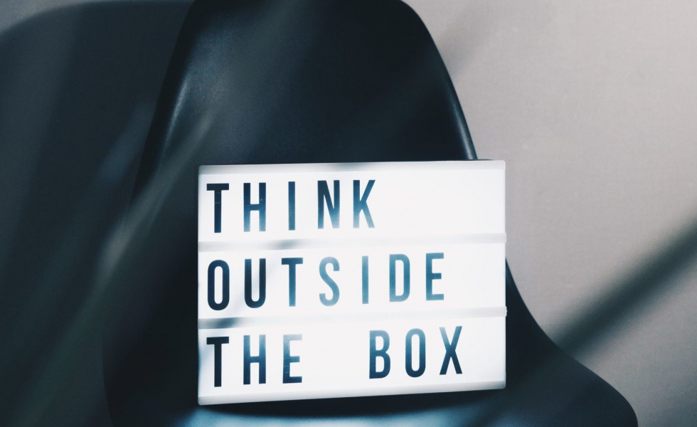 chair with a sign on it that says, "think outside the box"