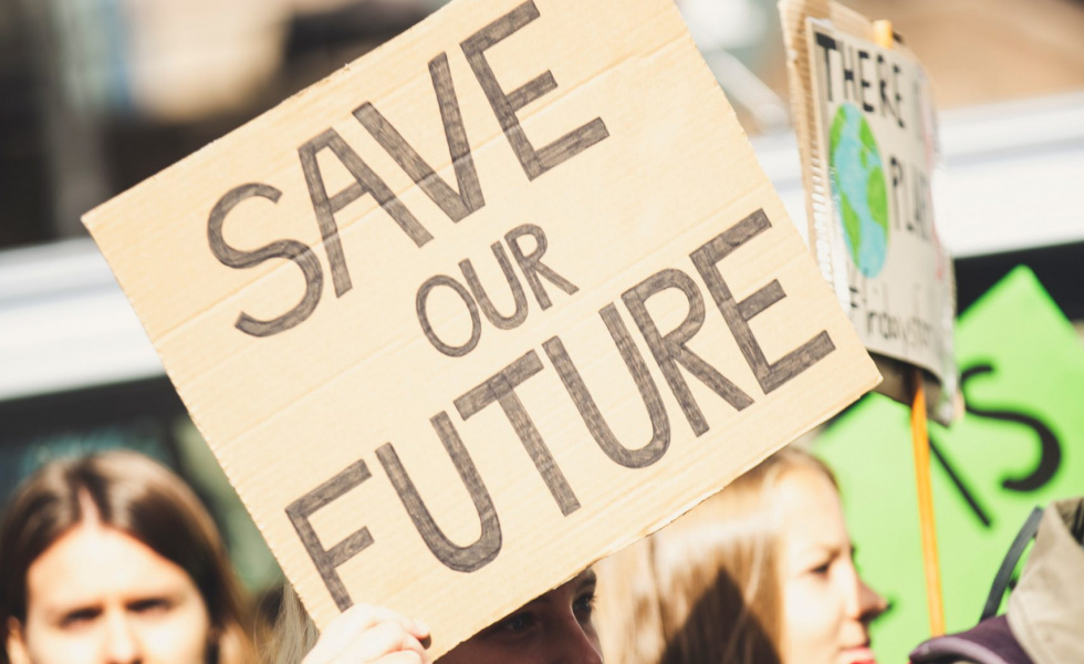 protestors hold signs that say "save our future"